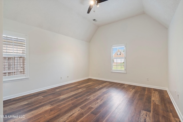 additional living space with ceiling fan, lofted ceiling, dark wood finished floors, and baseboards