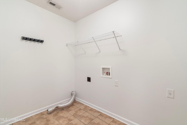 laundry area featuring hookup for an electric dryer, baseboards, hookup for a washing machine, and light tile patterned floors