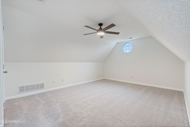 additional living space with carpet, ceiling fan, vaulted ceiling, and baseboards