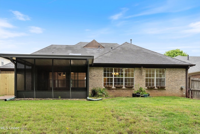 back of house featuring a sunroom, a shingled roof, and brick siding