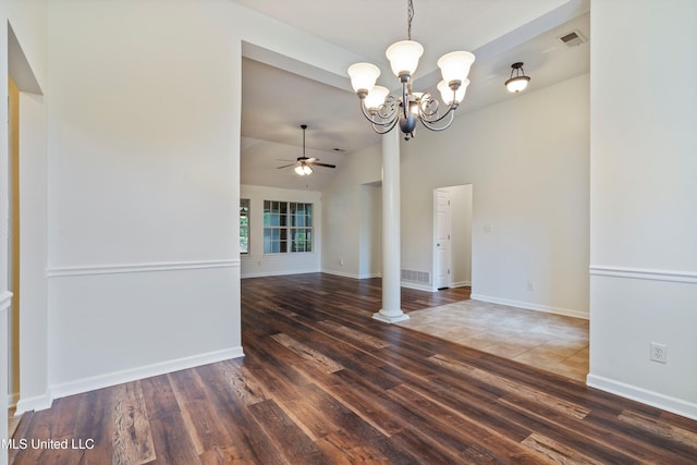spare room with wood finished floors, ceiling fan, a chandelier, baseboards, and ornate columns