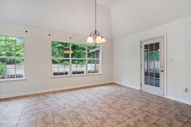 tiled spare room featuring a chandelier, baseboards, and high vaulted ceiling