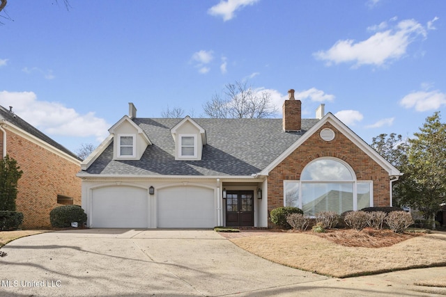 view of front of house with a garage and french doors