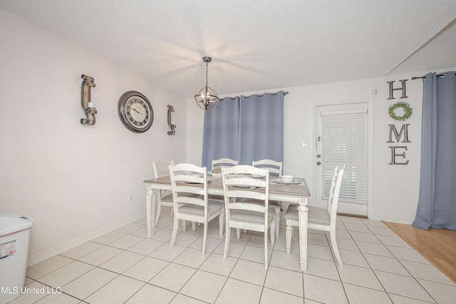 56 Lakeview Dr, Ocean Springs, MS 39564 - dining area with light tile patterned floors, a chandelier, and a textured ceiling