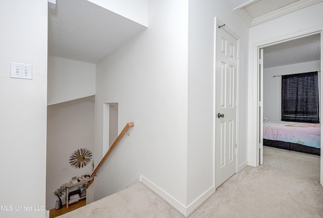 56 Lakeview Dr, Ocean Springs, MS 39564 - corridor featuring an upstairs landing, a textured ceiling, carpet floors, and attic access