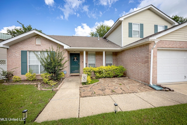 56 Lakeview Dr, Ocean Springs, MS 39564 - traditional-style house with brick siding, an attached garage, a front yard, and roof with shingles