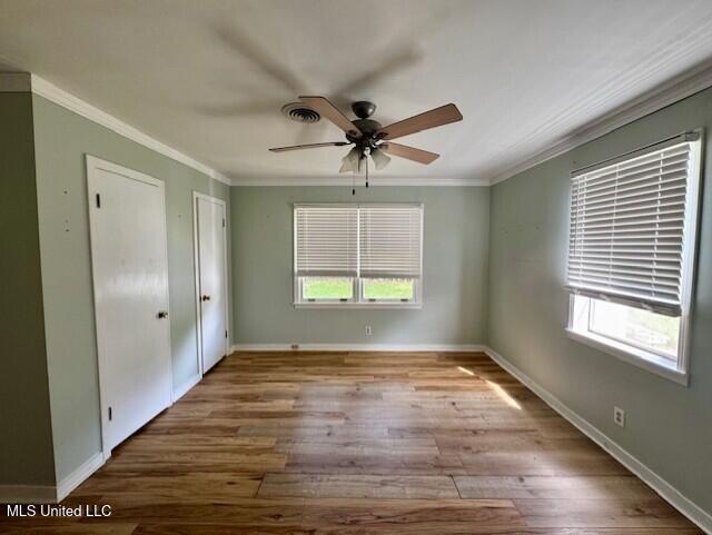106 Laurel Ave, Natchez, MS 39120 - spare room featuring ornamental molding, wood finished floors, a ceiling fan, and baseboards