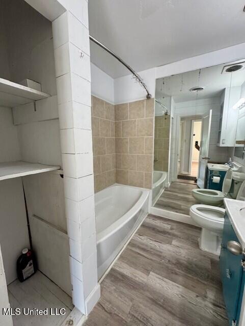 106 Laurel Ave, Natchez, MS 39120 - bathroom featuring vanity, wood finished floors, toilet, shower / bath combination, and a bidet