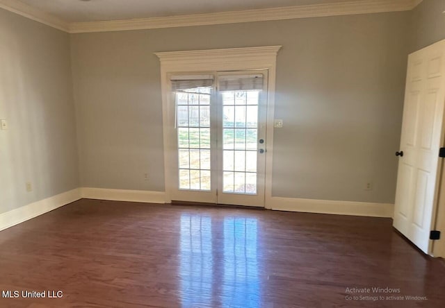 unfurnished room featuring crown molding, baseboards, and dark wood-type flooring