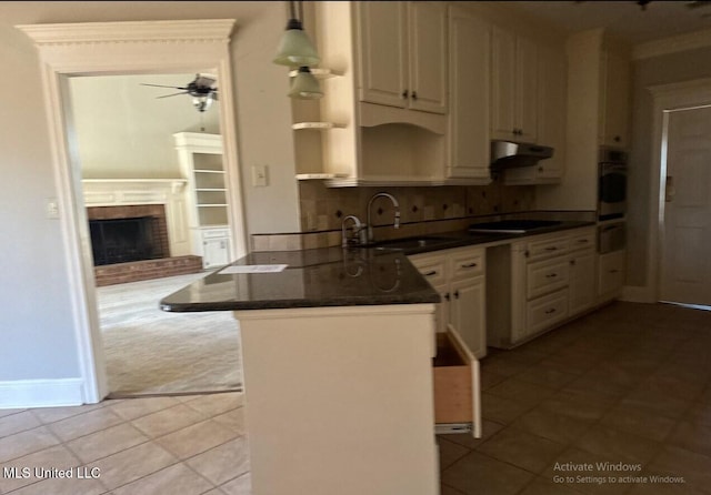 kitchen with a sink, oven, black electric stovetop, under cabinet range hood, and open shelves