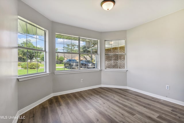 unfurnished room featuring hardwood / wood-style floors and a healthy amount of sunlight