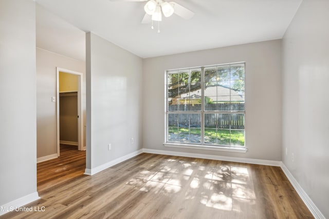 unfurnished room featuring ceiling fan and wood-type flooring