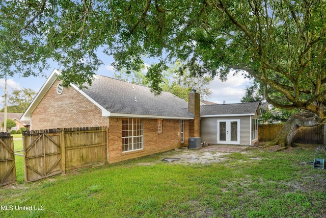 92 Hunter Dr, Ocean Springs, MS 39564 - back of house with french doors, a chimney, brick siding, and central AC unit