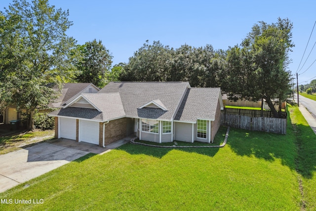 view of front of property featuring a front yard and a garage