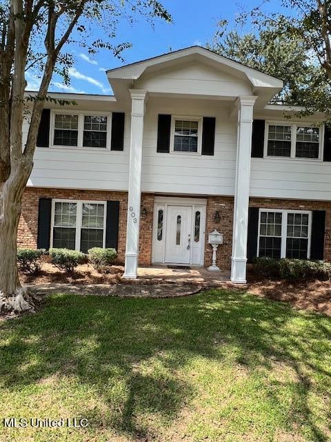 view of front of home featuring french doors and a front yard