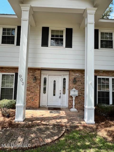 doorway to property featuring central AC