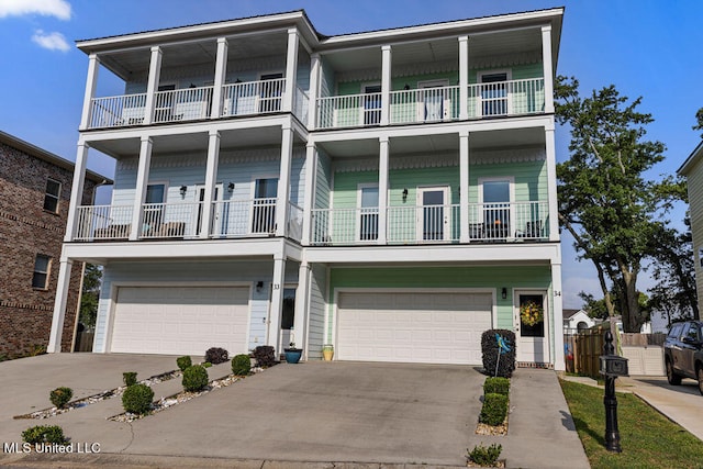 coastal home featuring a balcony and a garage