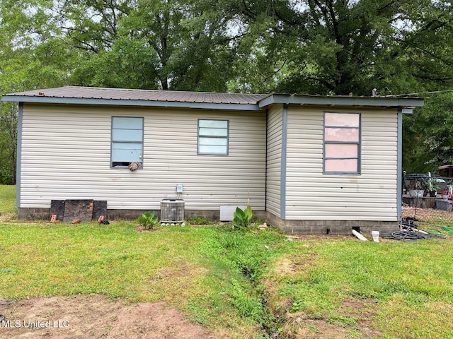 501 Liberty Church Rd, Nettleton, MS 38858 - back of property with a lawn, metal roof, and cooling unit