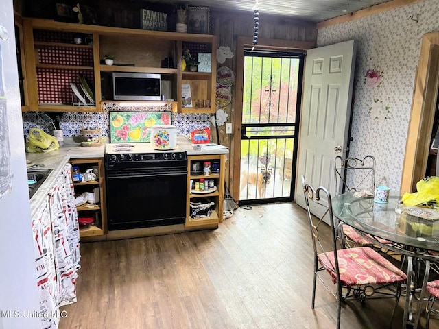 501 Liberty Church Rd, Nettleton, MS 38858 - kitchen featuring black electric range oven, open shelves, wallpapered walls, light wood finished floors, and light countertops