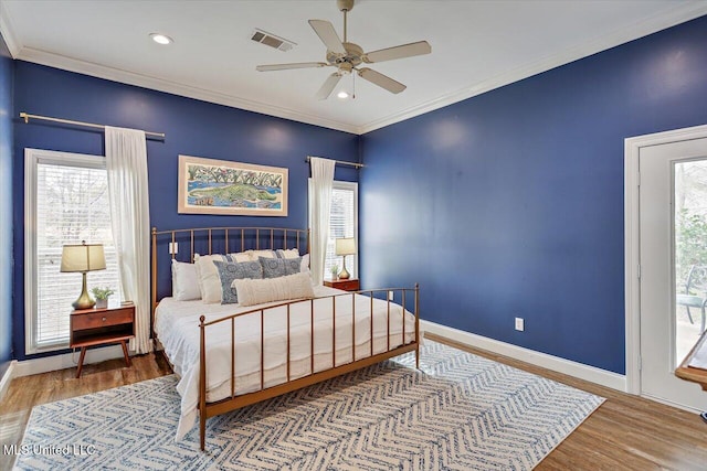 bedroom featuring ceiling fan, crown molding, and hardwood / wood-style floors