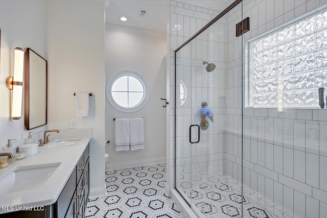 bathroom with tile patterned flooring, vanity, toilet, walk in shower, and crown molding