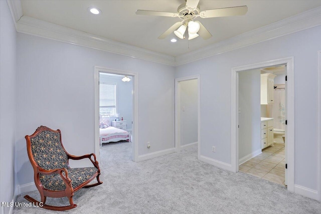 sitting room with light carpet, ceiling fan, and ornamental molding