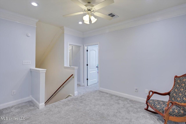 sitting room featuring ceiling fan, ornamental molding, and light colored carpet