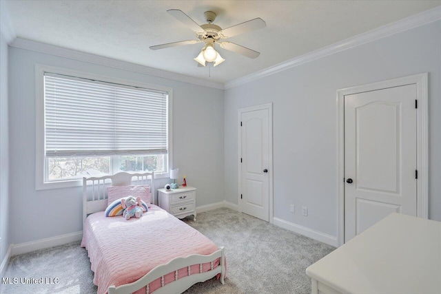 carpeted bedroom featuring ceiling fan and ornamental molding