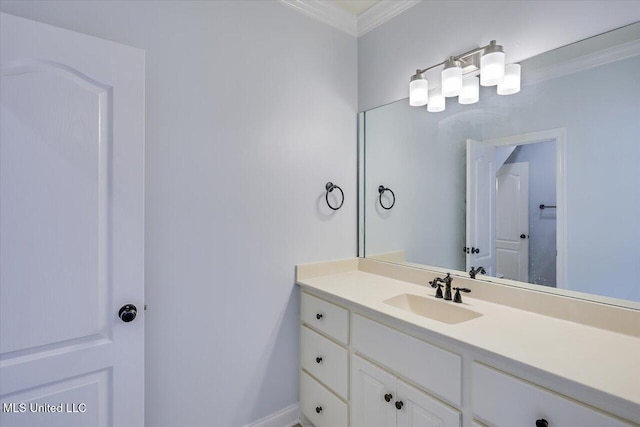 bathroom with ornamental molding and vanity