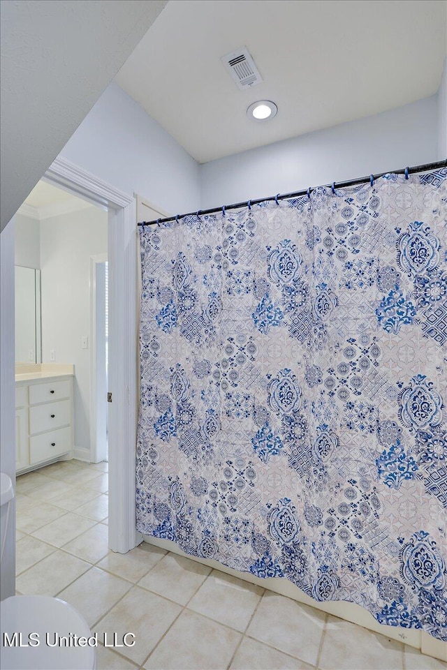 bathroom with tile patterned flooring and vanity