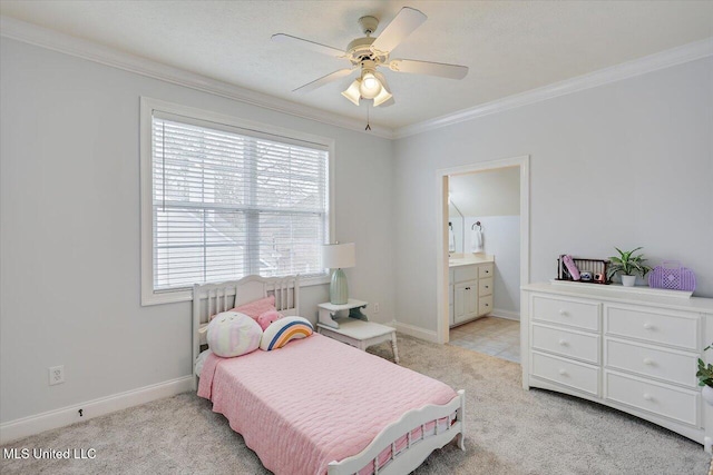 bedroom featuring ceiling fan, ensuite bathroom, crown molding, and light colored carpet