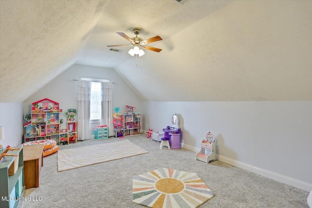 playroom featuring a textured ceiling, ceiling fan, lofted ceiling, and carpet floors