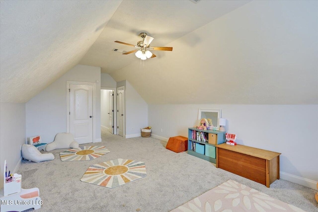 playroom with a textured ceiling, ceiling fan, lofted ceiling, and light colored carpet