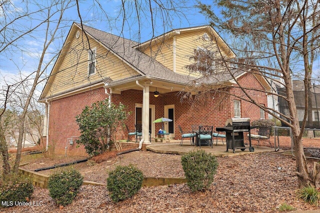 back of property featuring ceiling fan and a patio area