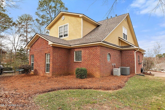 view of property exterior featuring central AC unit and a lawn