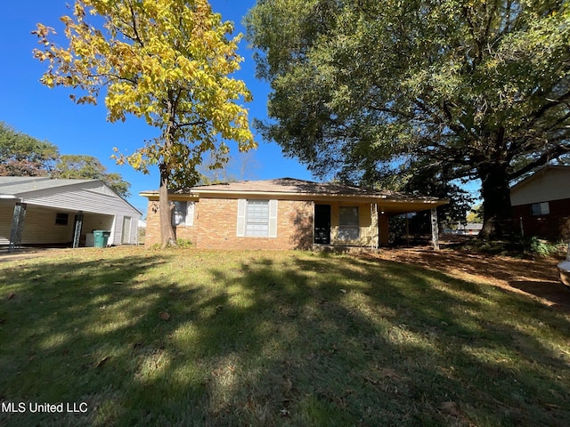 rear view of house featuring a lawn