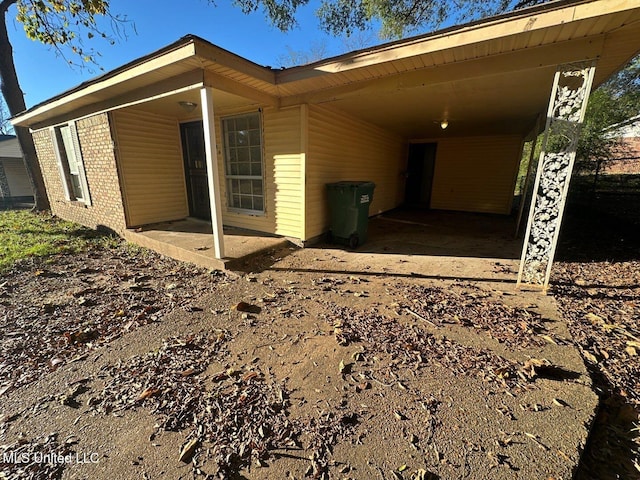 view of property exterior with a carport