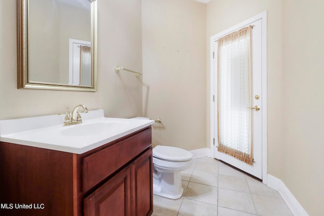 bathroom with tile patterned floors, vanity, and toilet