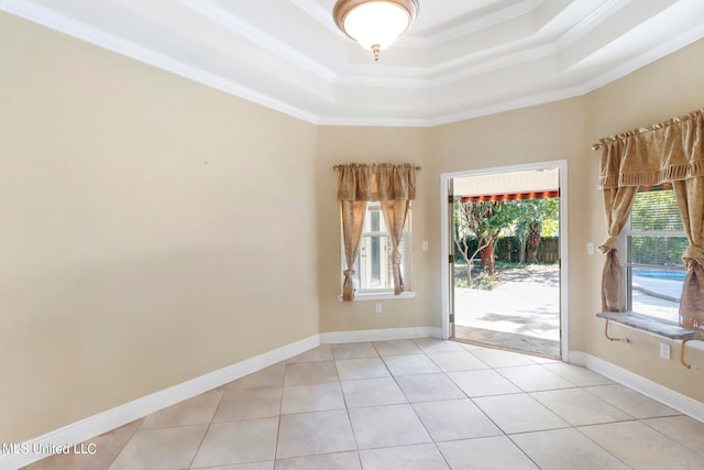 unfurnished room featuring light tile patterned floors, a tray ceiling, and ornamental molding