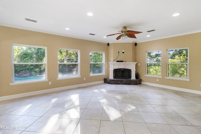 unfurnished living room with light tile patterned floors, ceiling fan, and ornamental molding