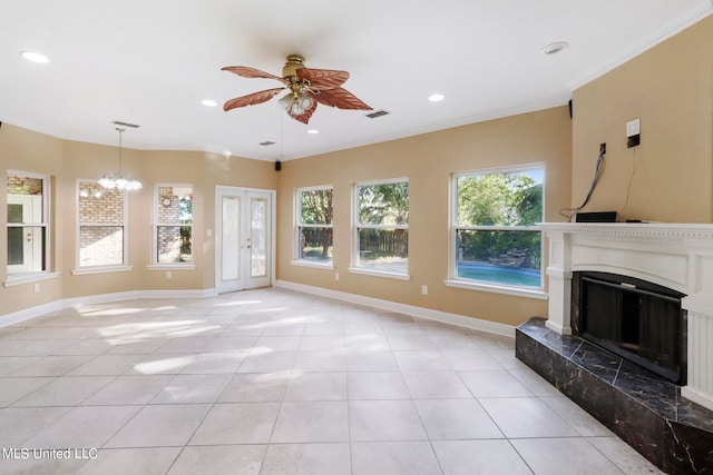 unfurnished living room featuring ceiling fan with notable chandelier, light tile patterned flooring, and a high end fireplace