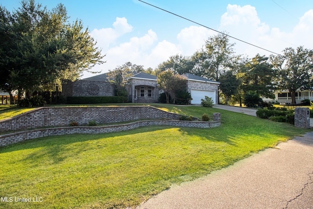 view of front of house with a garage and a front lawn