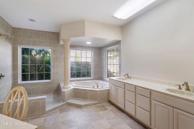 bathroom with vanity, separate shower and tub, and decorative columns