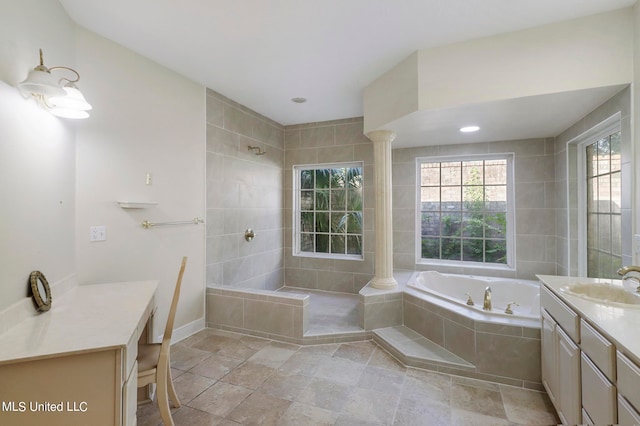 bathroom with vanity, ornate columns, and independent shower and bath