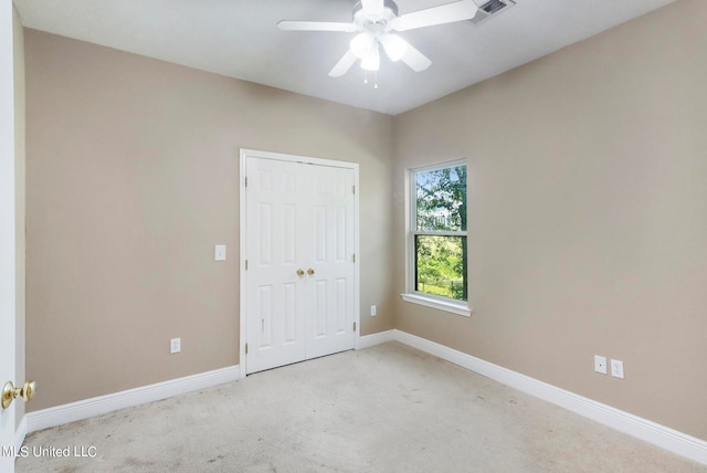 unfurnished room with light carpet and ceiling fan