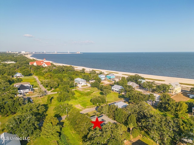 drone / aerial view featuring a water view and a view of the beach