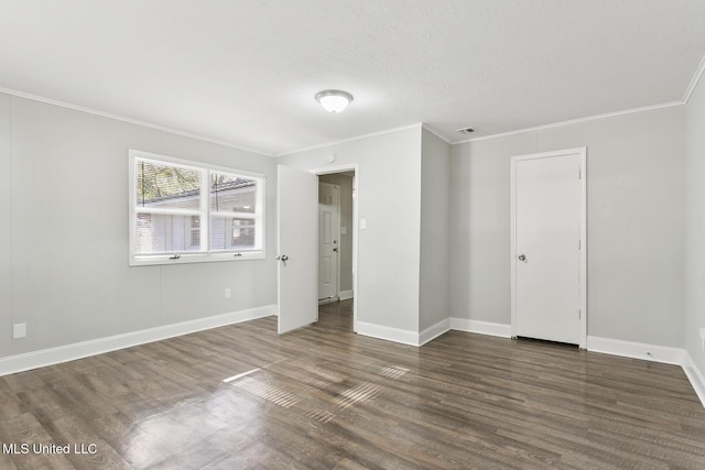 unfurnished bedroom featuring a textured ceiling, crown molding, and dark wood-type flooring