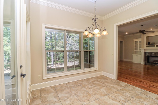 unfurnished dining area featuring ceiling fan, ornamental molding, and light tile patterned floors