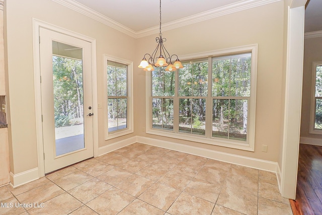 unfurnished dining area with plenty of natural light, ornamental molding, a notable chandelier, and light tile patterned flooring