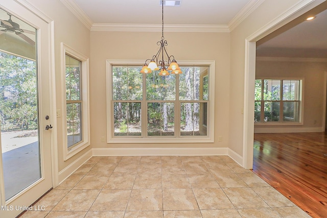 unfurnished dining area featuring light tile patterned floors, a notable chandelier, and ornamental molding